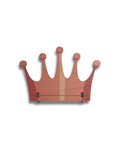 Handcrafted wooden crown-shaped wall decor in pink tones, minimalist design