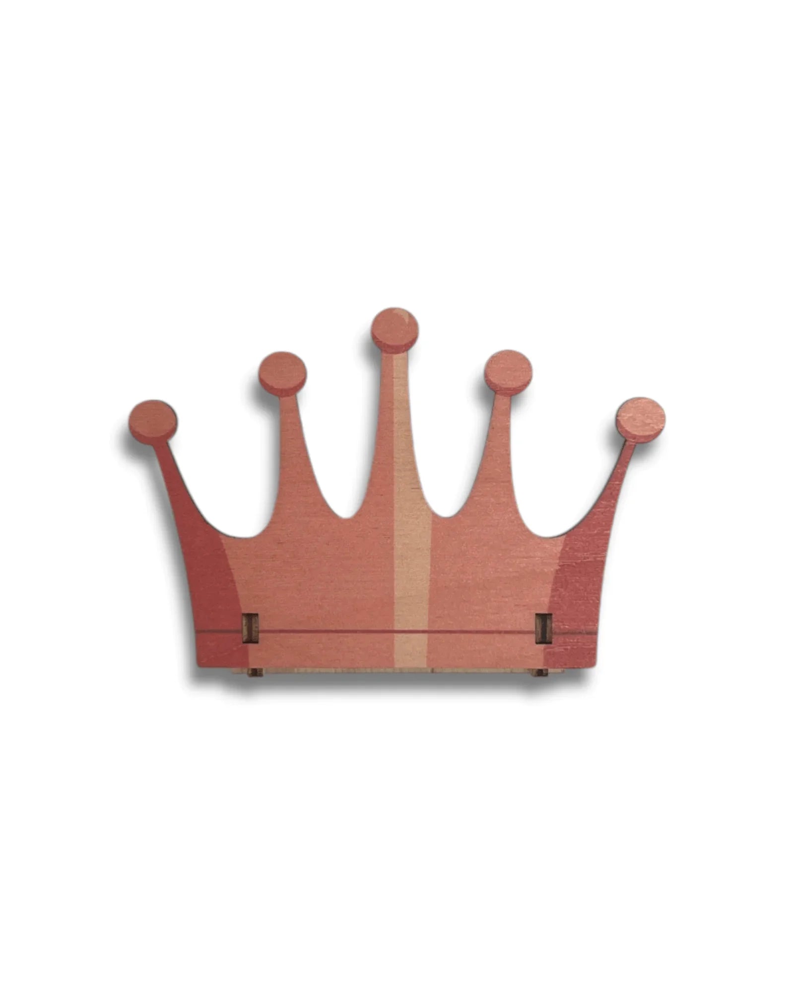 Handcrafted wooden crown-shaped wall decor in pink tones, minimalist design