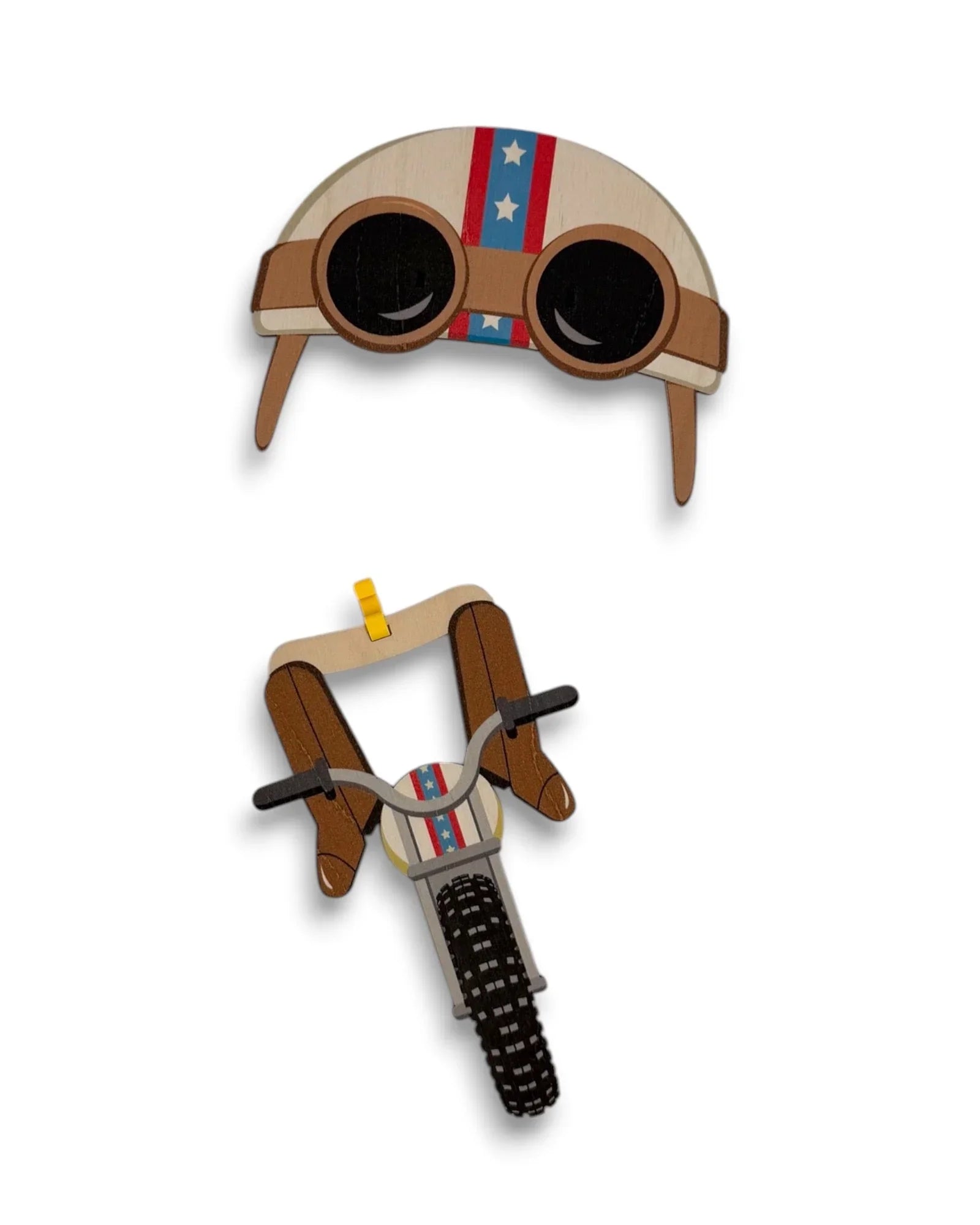 Wooden wall art of a biker dog helmet and motorcycle handlebars with stars and stripes design.