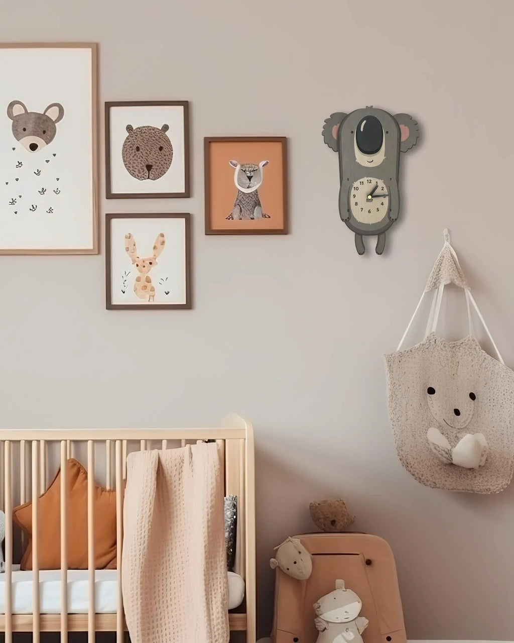 Kids bedroom with animal wall art, a koala-shaped clock, wooden crib, and plush decor.