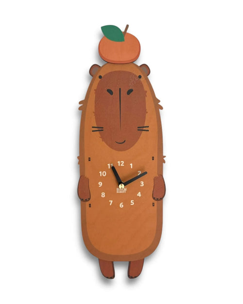 Handcrafted animal wall clock shaped like a brown capybara with an orange fruit on its head